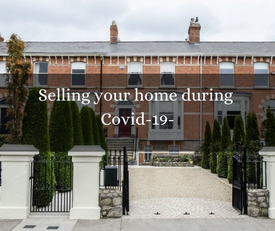 Victorian Dublin house with a blue door and a white window with black gates and front garden