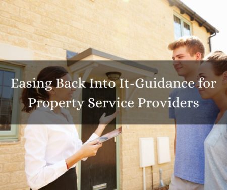 real estate agent showing a young couple a new house outside