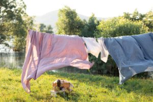 purple, tidy, clean, comfortable clothes out line-drying on a hot day blowing in the wind