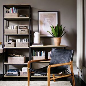 books stored in wicker baskets in a living room