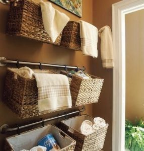 towels stored in hanging baskets in a clean and organised bathroom