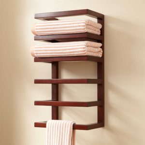 wooden towel rack installed on a bathroom wall