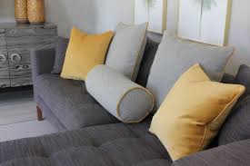 yellow and grey cushions on a grey sofa in a living room